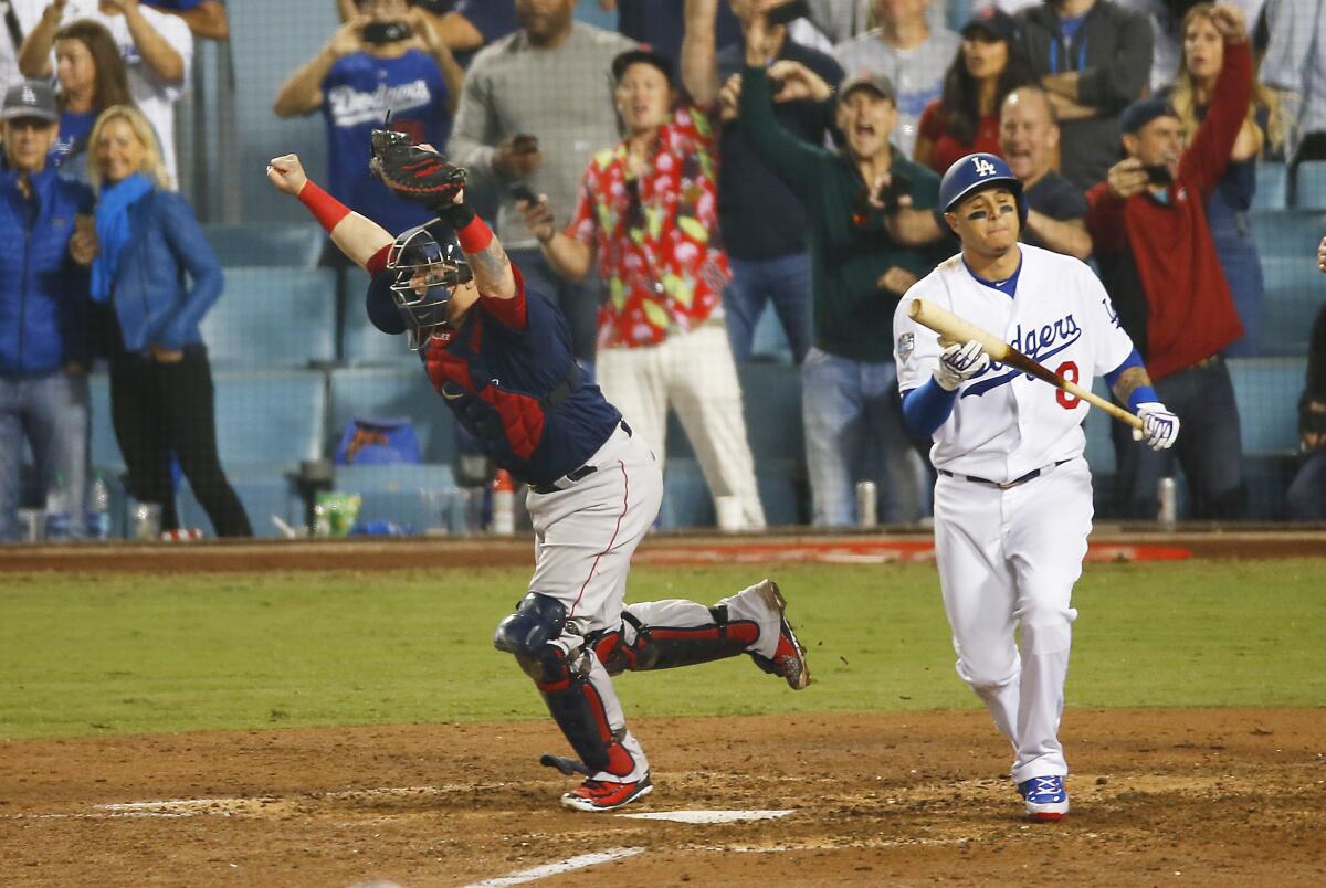 Boston Red Sox catcher Christian Vazquez celebrates after the Dodgers' Manny Machado strikes out.