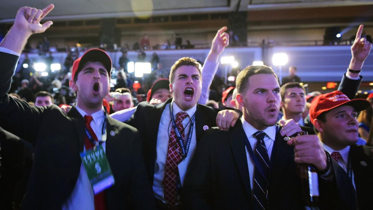 Supporters of Republican presidential nominee Donald Trump react to early results during election night at the New York Hilton on Nov. 8.