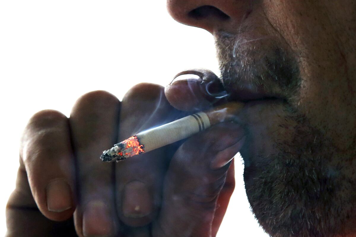 In this 2014 file photo, a man smokes a cigarette.