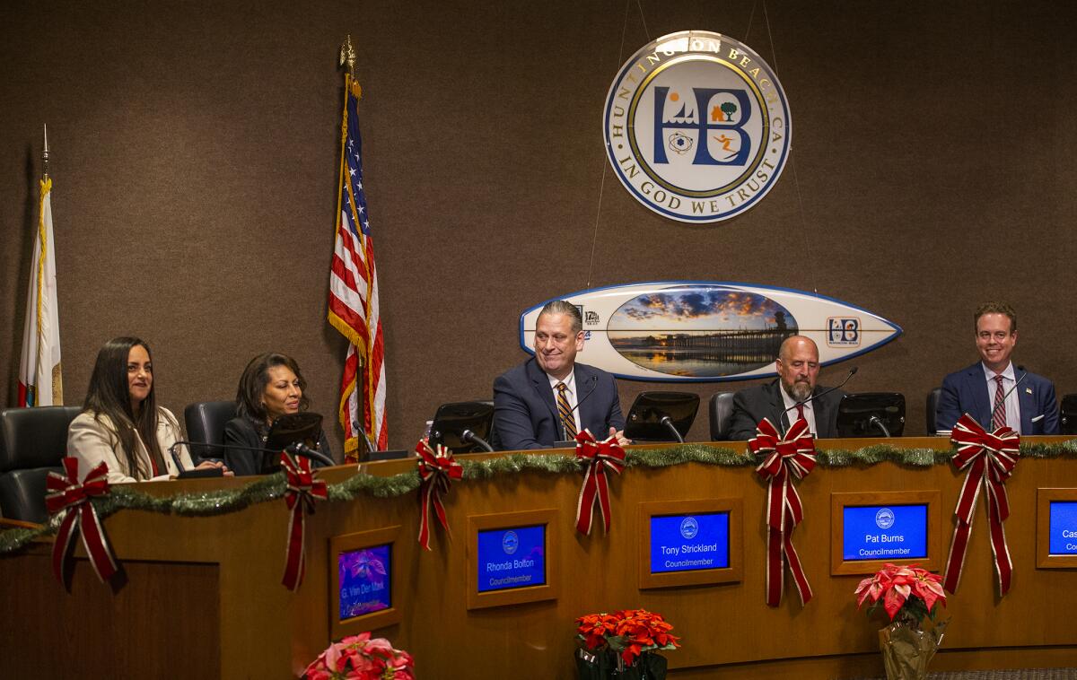 Newly elected members of the Huntington Beach City Council sit on the dais during their swearing in ceremony on Dec. 6, 2022.