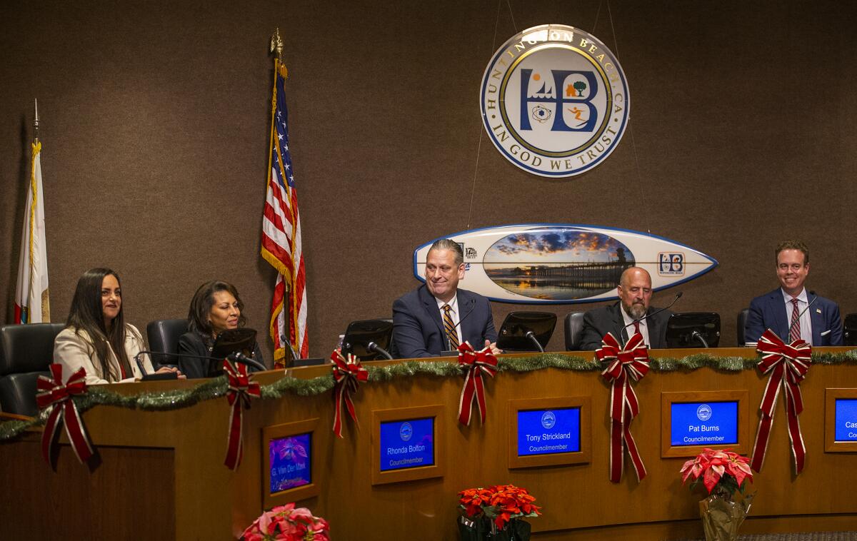 Newly elected members of the Huntington Beach City Council sit on the dais during Tuesday's meeting.