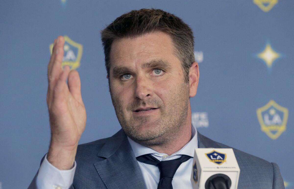 File-This Dec. 13, 2016, file photo shows Curt Onalfo being introduced as the new head coach of the Los Angeles Galaxy soccer team at news conference in Carson, Calif. The Galaxy fired Onalfo Thursday, July 27, 2017, just 20 games into his first season. The Galaxy hired veteran MLS coach Sigi Schmid to return to the struggling club.