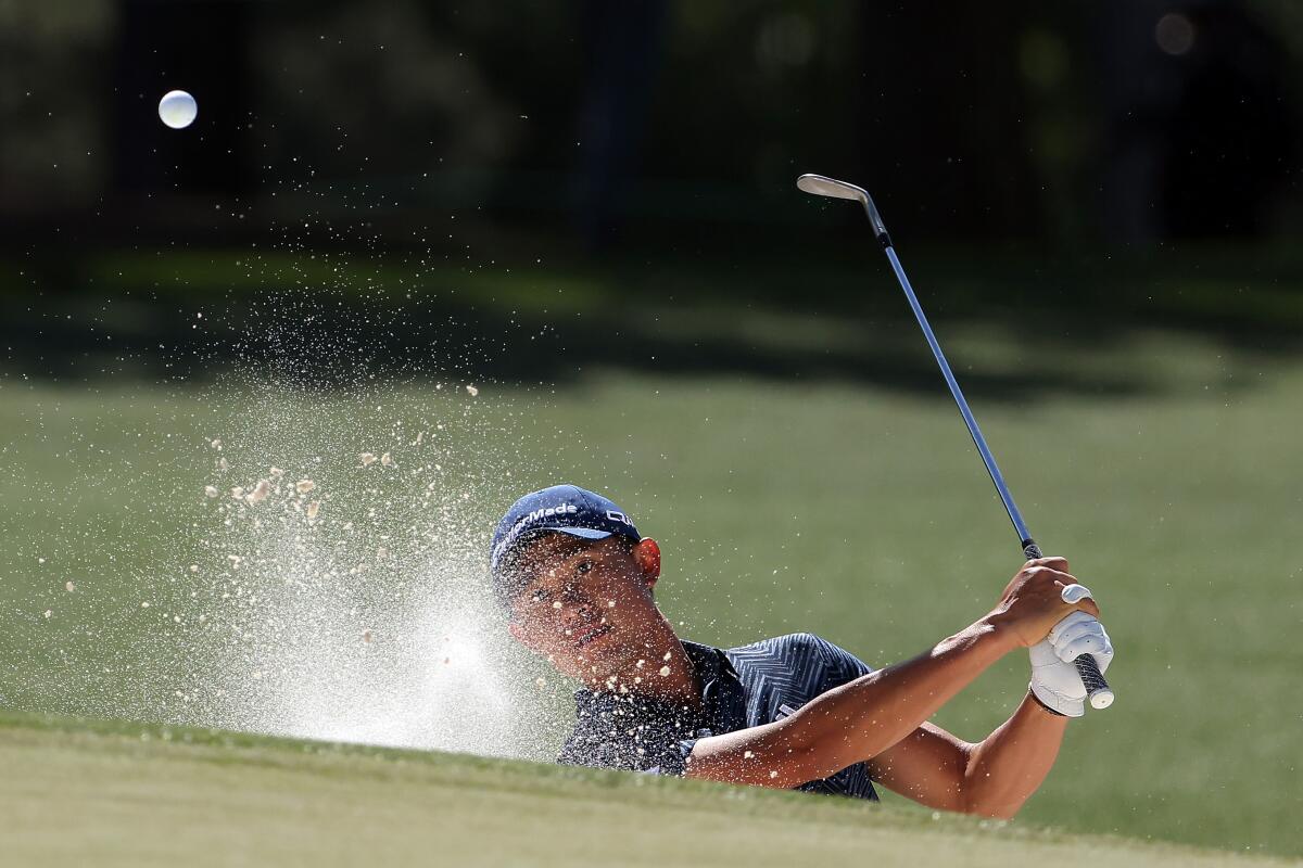 Collin Morikawa hits out of a bunker on the 17th hole during the second round of the Masters on Friday.