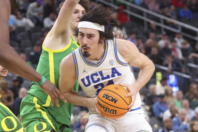 UCLA guard Jaime Jaquez Jr. (24) drives to the basket against Oregon center Nate Bittle during the first half.