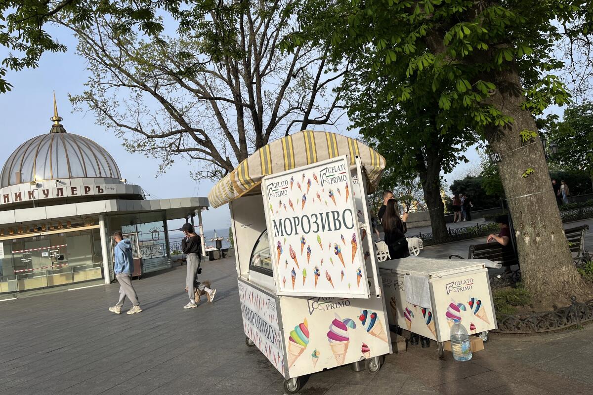 An ice cream stand on a public promenade 