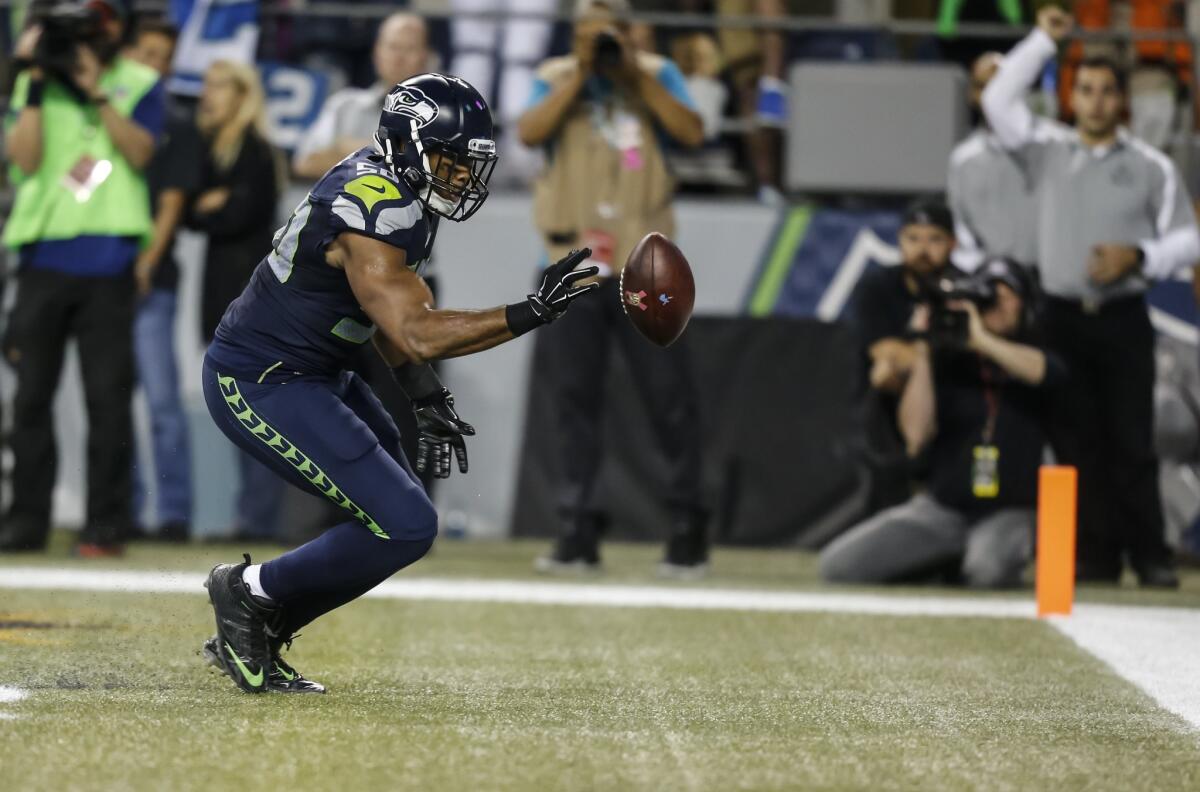 Seattle linebacker K.J. Wright bats a loose ball out of the back of the end zone against Detroit on Monday night.