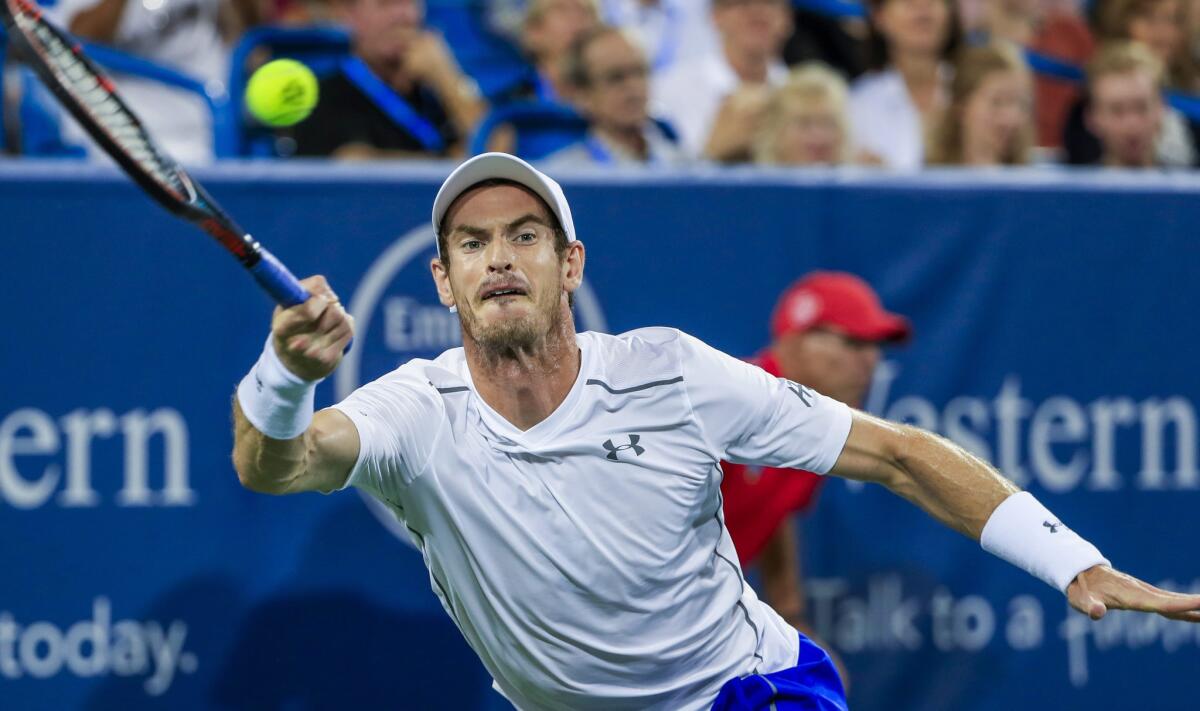 Andy Murray hits a return shot against Juan Monaco during a second round match at the Western & Southern Open tennis championships at the Linder Family Tennis Center in Mason, Ohio.