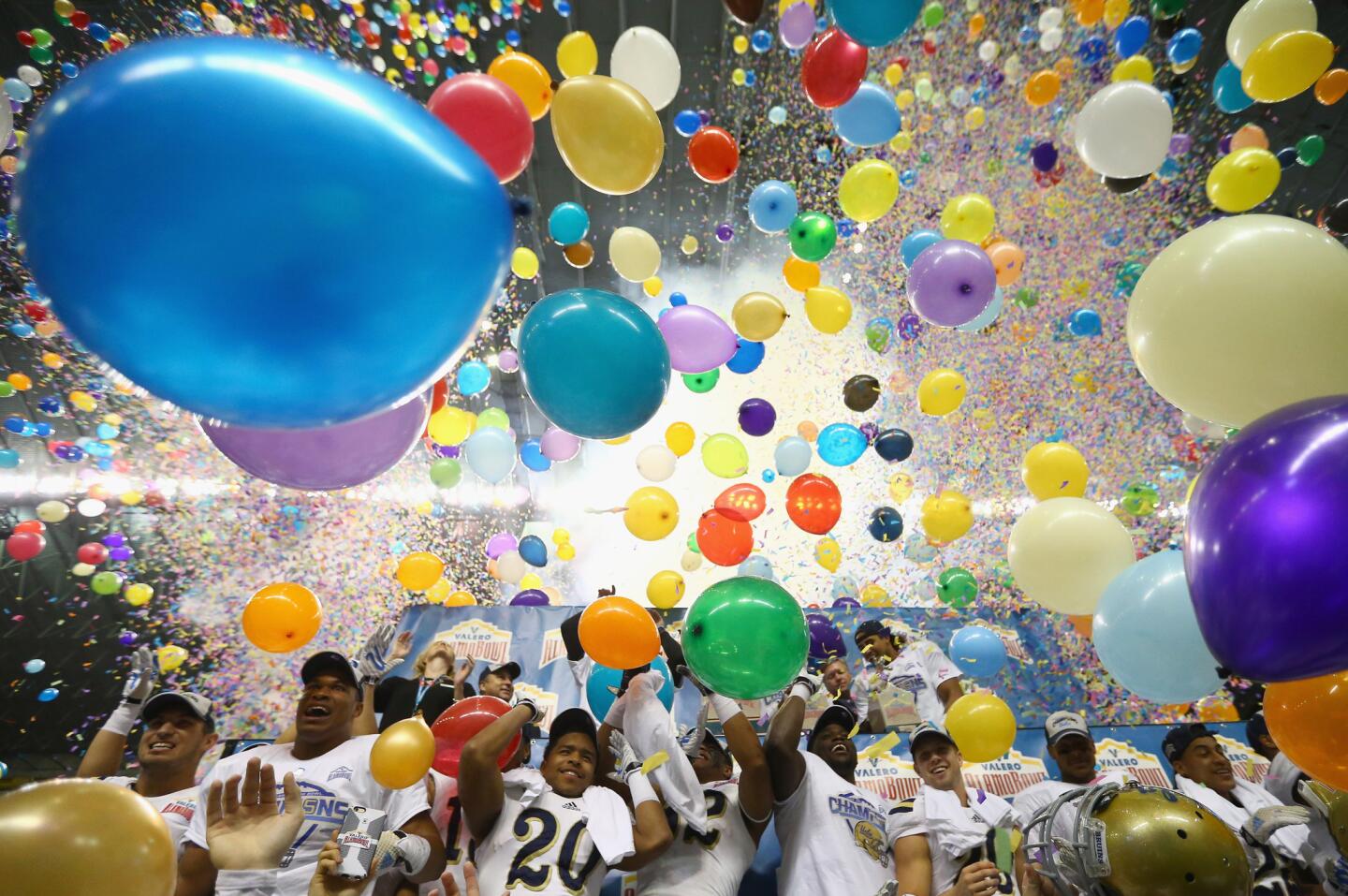 Balloons drop from the ceiling of the Alamodome as UCLA celebrates its 40-35 win over Kansas State at in the Alamo Bowl.