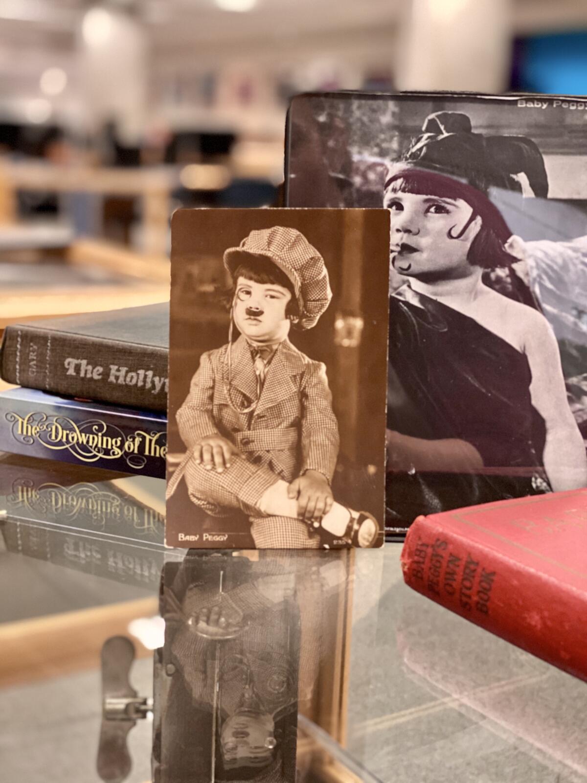 UCSD’s Geisel Library exhibit, ‘Diana Serra Cary: The Last Living Silent Film Star,’ includes photos of Baby Peggy from her films, as well as books she authored after her retirement from the university.