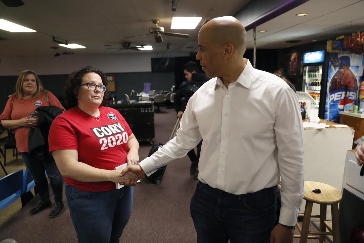 Bridget Carberry Montgomery shakes hands with Cory Booker.