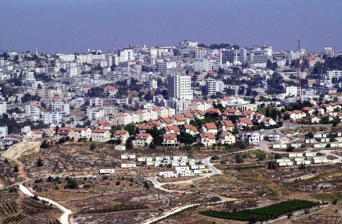 The Jewish West Bank settlement of Psagot, foreground houses with red roofs, adjacent to the West Bank city of Ramallah, in 2000.