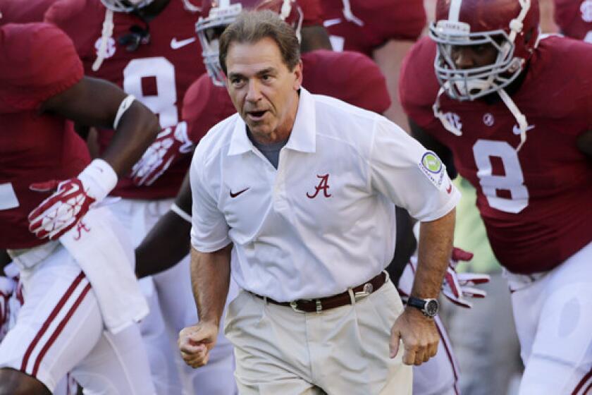Alabama Coach Nick Saban leads his team onto the field before a 2013 game against Mississippi. Saban has been one of the most vocal supporters of a proposed new college football rule that would penalize teams that snap the ball before 10 seconds have passed on the 40-second play clock.