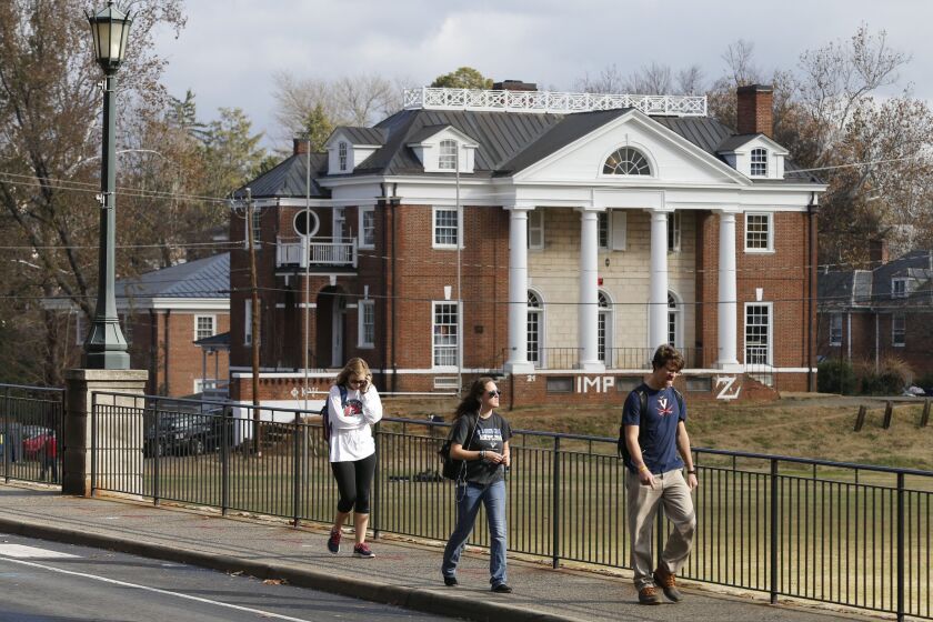University of Virginia students walk to campus on Nov. 24 past the Phi Kappa Psi fraternity house at the University of Virginia in Charlottesville, Va.