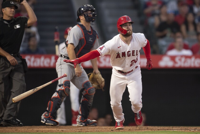 Angels' Jared Walsh tosses his bat and heads for first base after hitting a home run