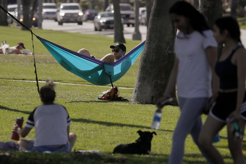 LONG BEACH, CALIF. - MAY 6, 2020. Jeremy Moskovitz practices physical distancing along with other visitors to Bluff Park in Long Beach, where temperatures reached into the low 90s on Wednesday, May 6, 2020. (Luis Sinco/Los Angeles Times)