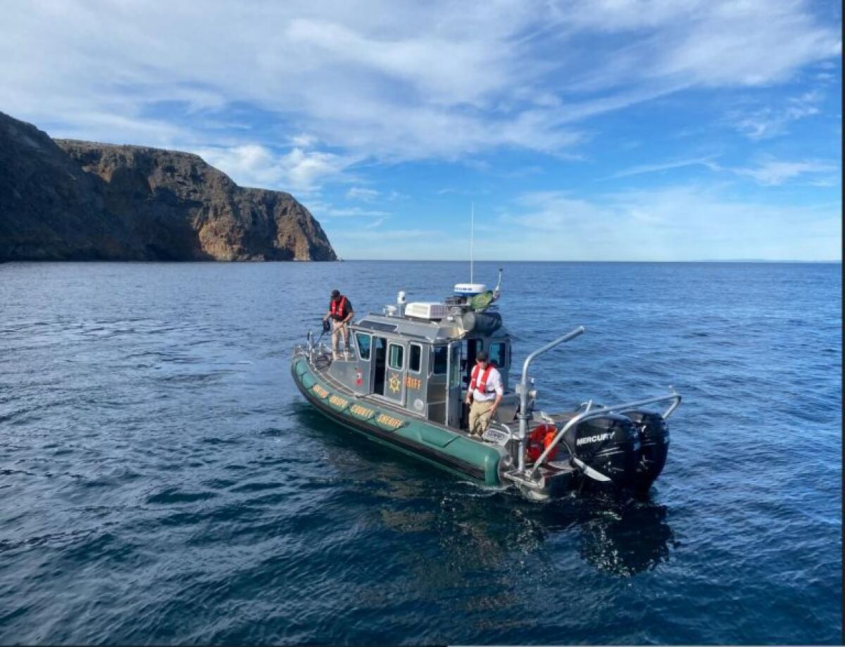 Sheriff officials stand on a boat near Santa Cruz Island 