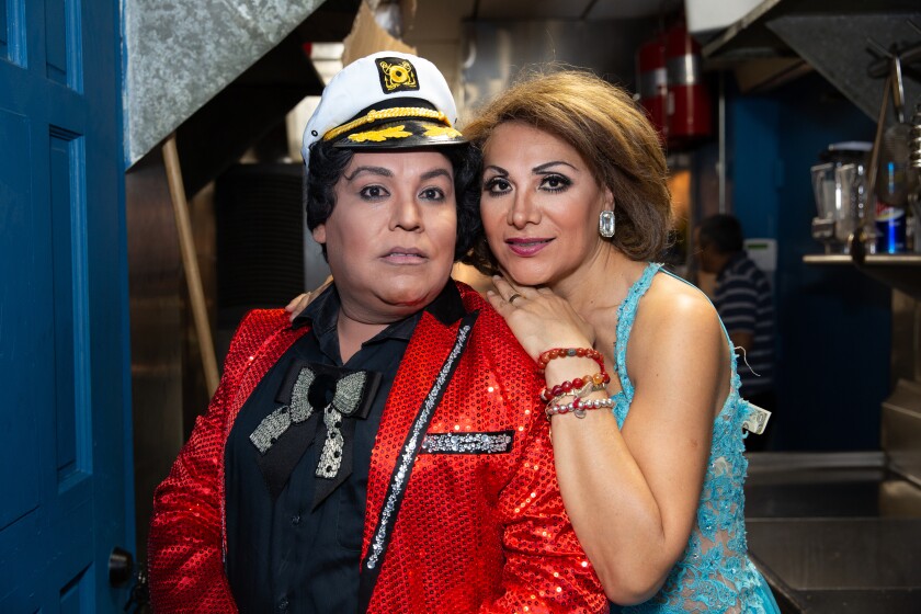 For her "Caricias" project, Arlene Mejorado photographed Yosi Love dressed as Juan Gabriel and Moni Leon dressed as Rocio Durcal by the kitchen of a Boyle Heights restaurant where families gather on weekends to watch tribute artists. 