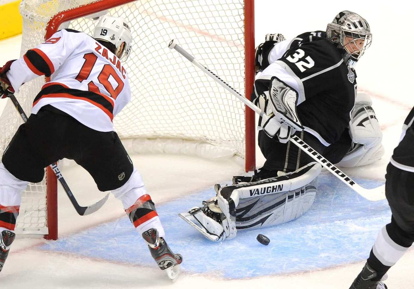 Kings goalie Jonathan Quick makes a save as New Jersey forward Travis Zajac tries to get to a rebound during the Kings' 4-0 victory in Game 3 of the Stanley Cup Final at Staples Center.
