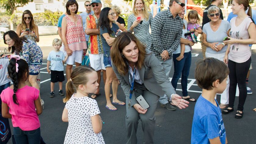 Laura Canzone, then known as Laura Sacks, greets students as principal of Mariners Elementary School in Newport Beach in September 2015.