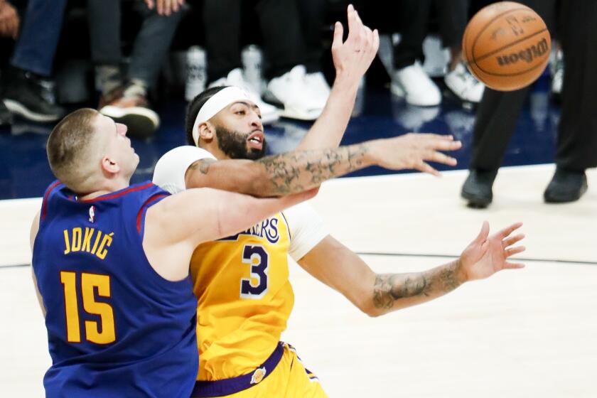DENVER, CO - MAY 16: Los Angeles Lakers forward Anthony Davis, right, and Denver Nuggets center Nikola Jokic battle for the ball during the second half of game one in the NBA Playoffs Western Conference Finals at Ball Arena on Tuesday, May 16, 2023 in Denver, CO. (Robert Gauthier / Los Angeles Times)