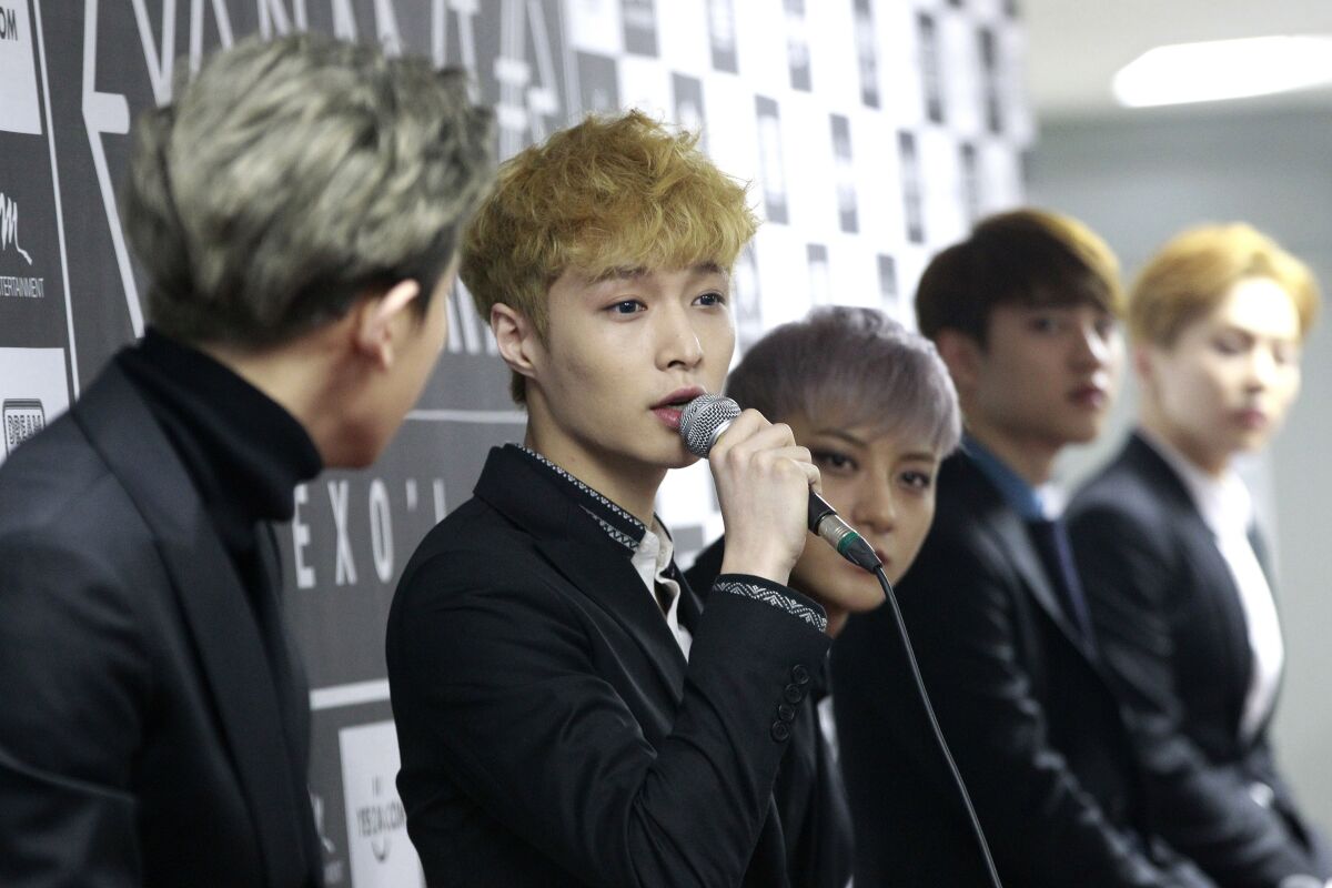 FILE - In this March 8, 2015, file photo, South Korean K-pop group EXO member Lay, second from left, speaks during a press conference in Seoul, South Korea. At least eight K-pop stars from China and even one from Taiwan and one from Hong Kong are publicly stating their support for the one-China policy, eliciting a mixture of disappointment and understanding from fans. It’s the latest example of how celebrities and companies feel the pressure to toe the line politically in the important Chinese market. (AP Photo/Ahn Young-joon, File)