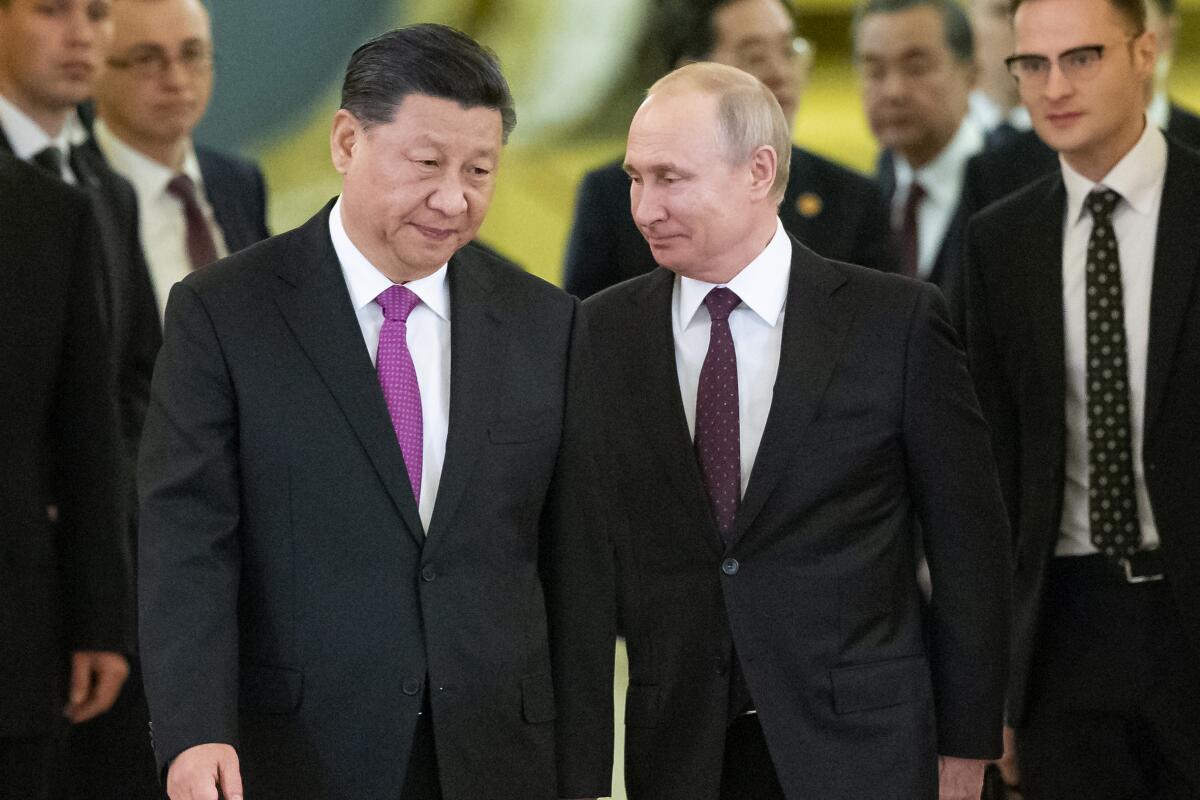 FILE - In this June 5, 2019, file photo, Russian President Vladimir Putin, center right, and Chinese President Xi Jinping, center left, enter a hall for talks in the Kremlin in Moscow, Russia. Putin and Xi have developed strong personal ties helping bolster a “strategic partnership” between the two former Communist rivals. (AP Photo/Alexander Zemlianichenko, Pool, File)