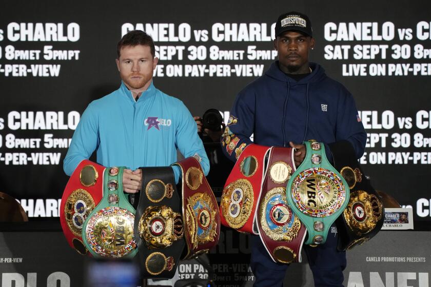 Canelo Alvarez, left, of Mexico, and Jermell Charlo pose during a news conference Wednesday, Sept. 27, 2023, in Las Vegas. The two are scheduled to fight in a super middleweight title boxing match Saturday in Las Vegas. (AP Photo/John Locher)