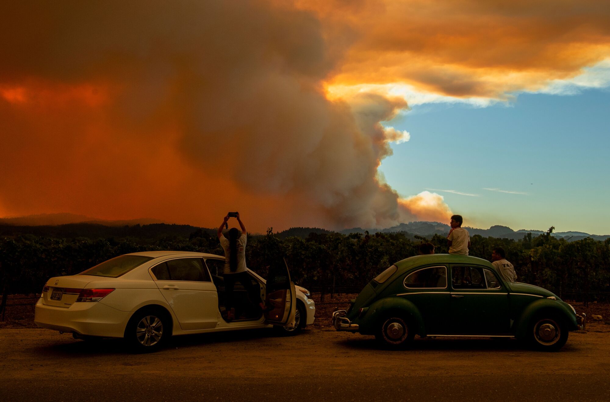 People watch a wildfire in Healdsburg, Calif.