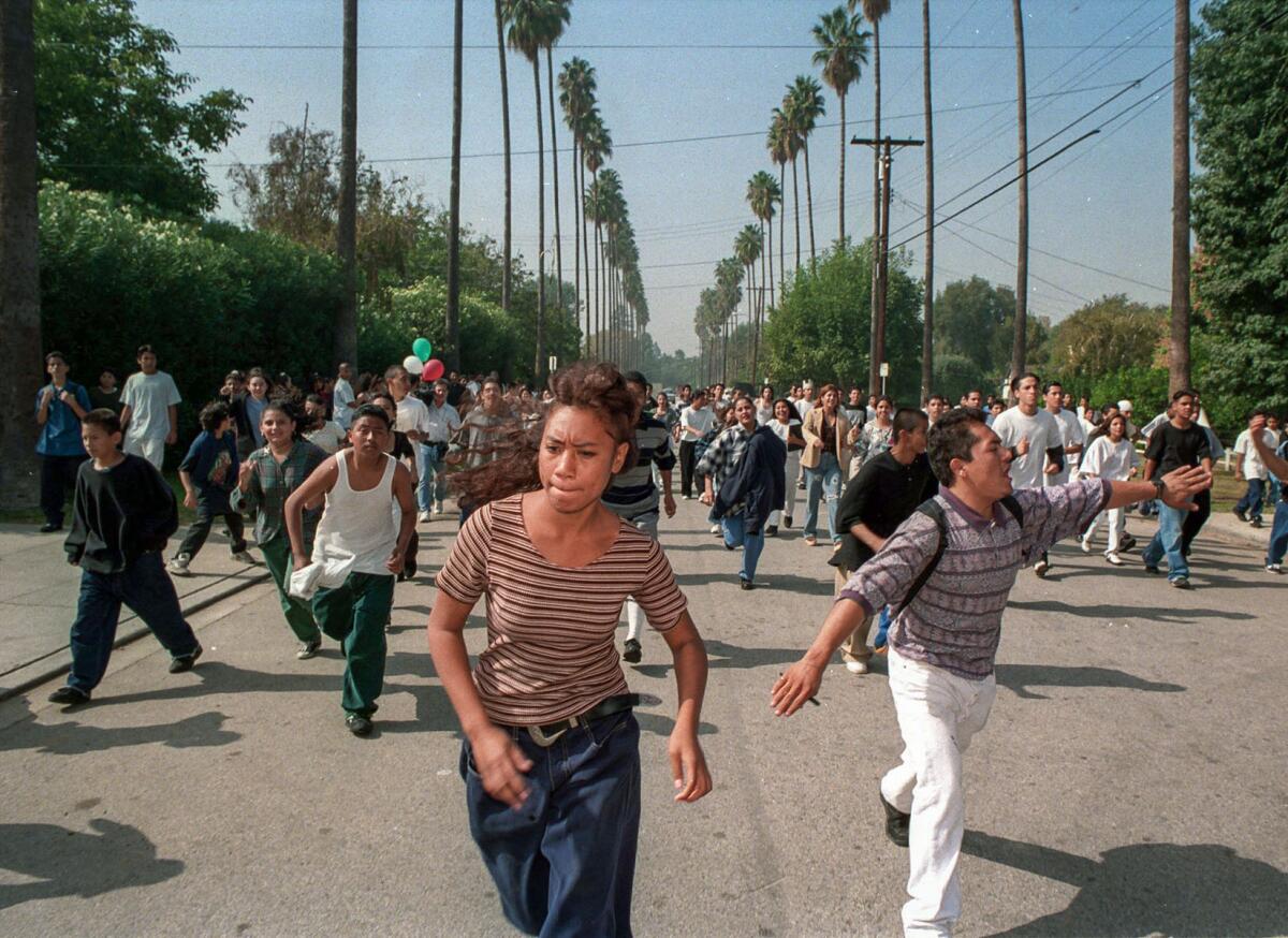Oct. 28, 1994: Student demonstrators from Monroe High School run toward a police blockade of Van Nuys High School during anti-Proposition 187 walkout.