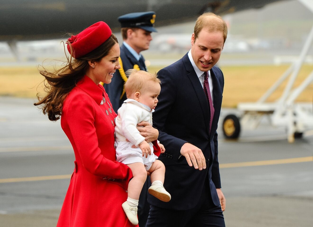 The royals make their way across the tarmac in New Zealand to begin their three-week tour of that country and Australia.