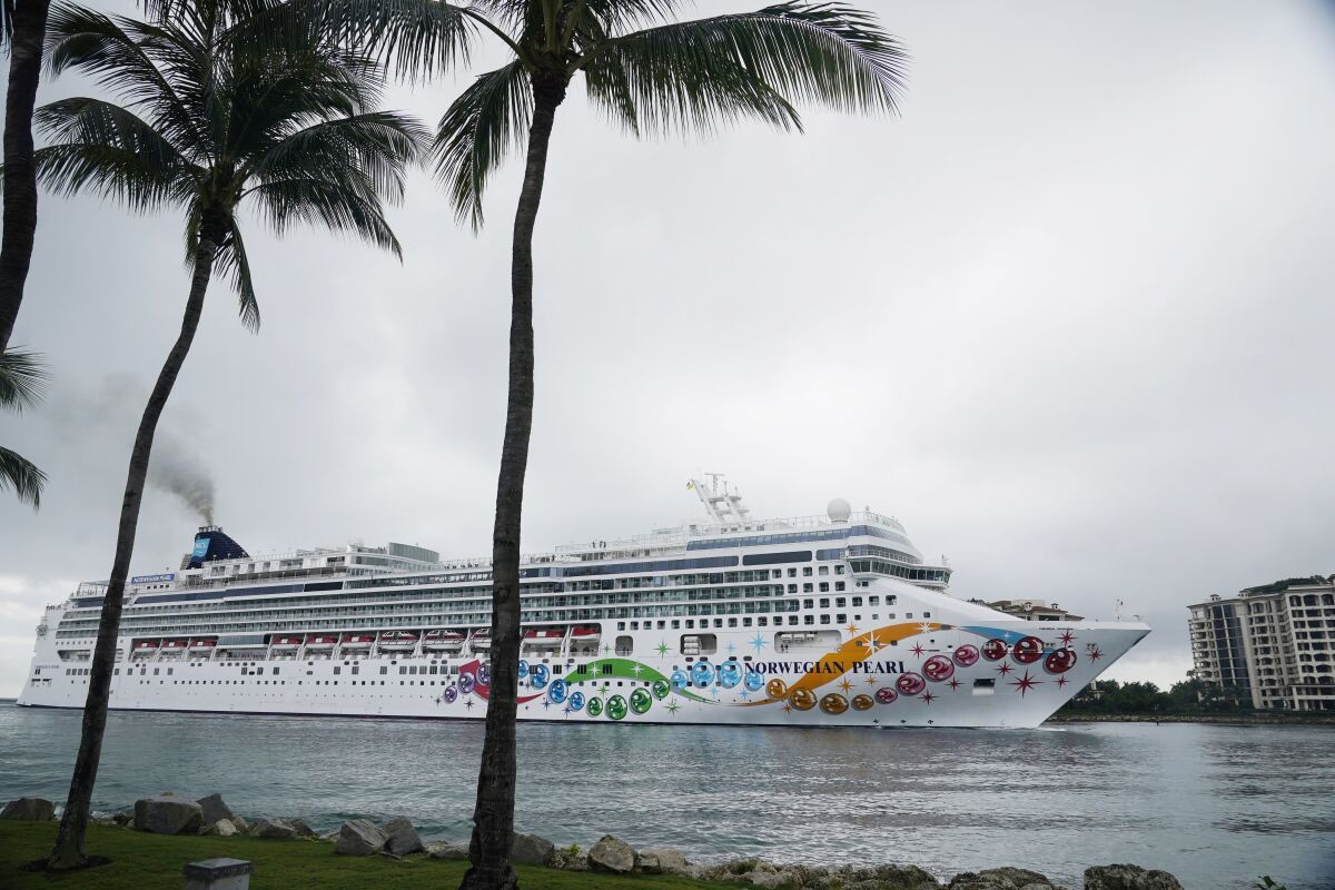 The Norwegian Pearl cruise ship sails to PortMiami, Wednesday, Jan. 5, 2022, in Miami. The ship left on Monday on an 11-day trip to the Panama Canal, but it had to return after several crew and staff tested positive for COVID-19. (AP Photo/Marta Lavandier)