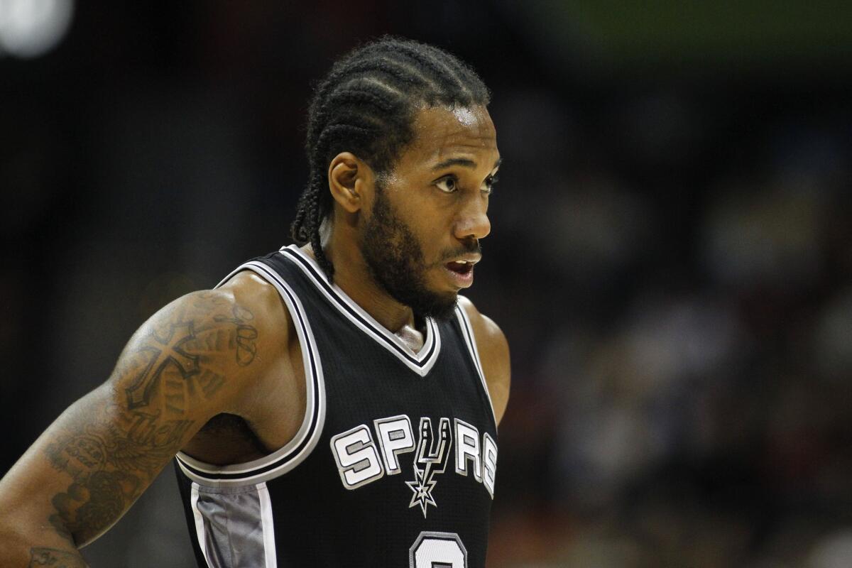 Spurs forward Kawhi Leonard takes a breath in between the first half action of a game against the Hawks.