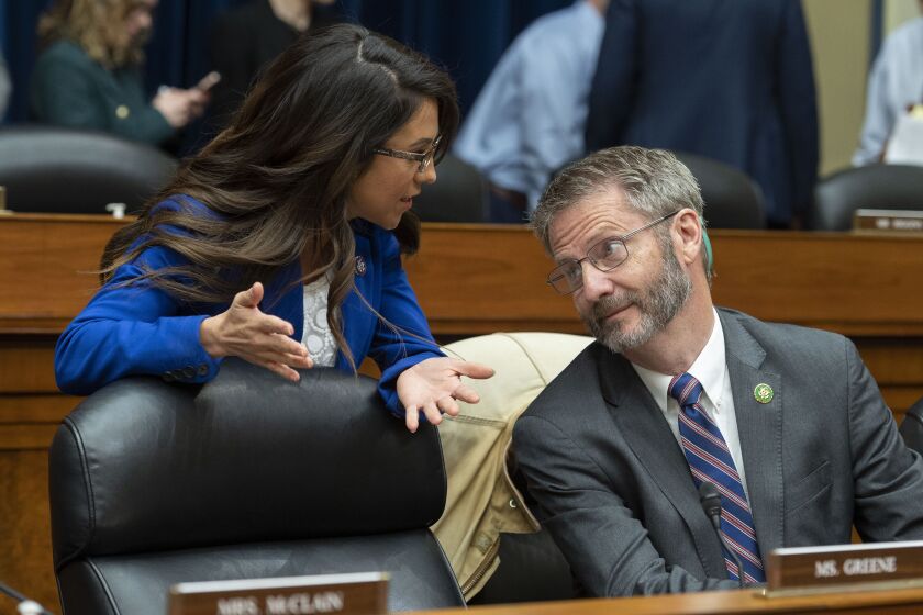 Rep. Lauren Boebert, R-Colo., speaks with Rep. Tim Burchett, R-Tenn., speak during a House Oversight and Accountability Committee's hearing about Congressional oversight of the Nation's Capital, Wednesday, March 29, 2023, on Capitol Hill in Washington. (AP Photo/Cliff Owen)
