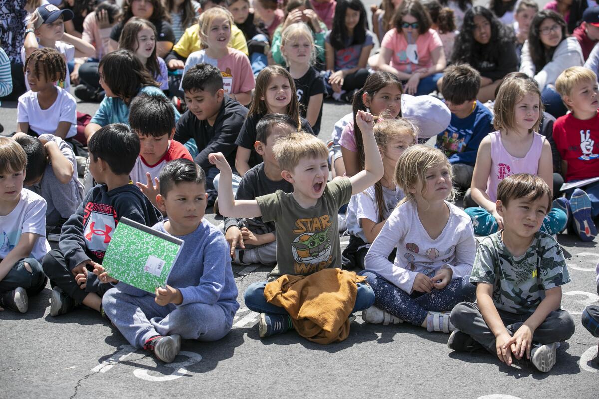 A student cheers for an award recipient during an assembly at Golden View Elementary on Wednesday in Huntington Beach.
