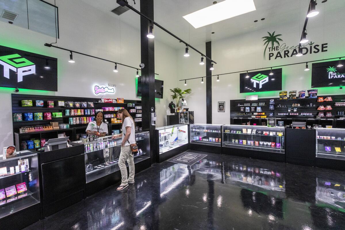 An interior view of a dispensary showing product on the shelves and in glass cases