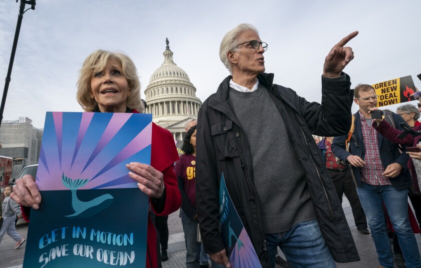 Actress and activist Jane Fonda, left, is joined by actor Ted Danson as they and other demonstrators call on Congress for action to address climate change in Washington on Friday.