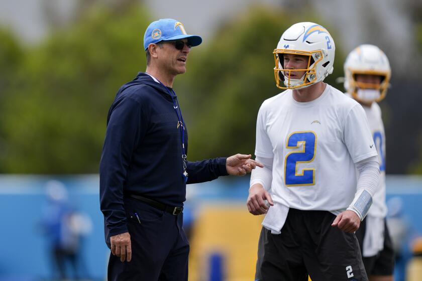 Chargers coach Jim Harbaugh talks to  quarterback Easton Stick (2).