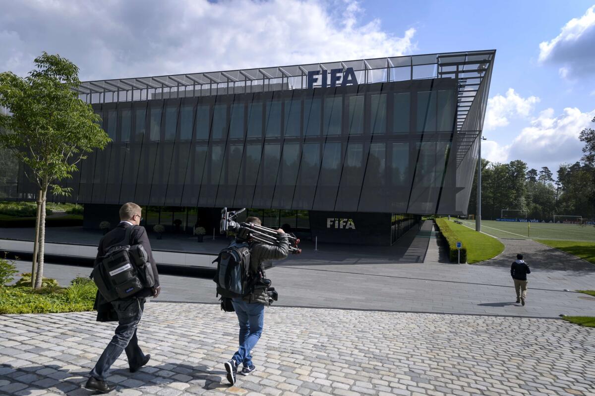 A TV crew arrives at FIFA headquarters in Zurich on Wednesday after the arrest of several high-ranking officials at the request of the U.S. Justice Department.