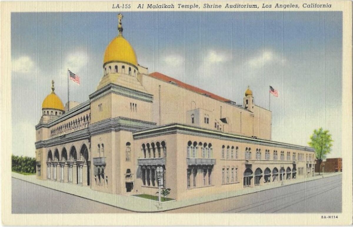 Gold domes and waving flags above the Shrine Auditorium