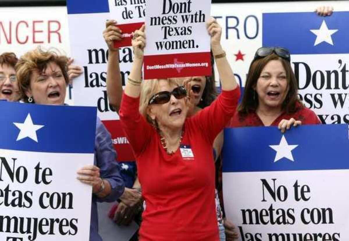 Women in San Antonio rally in March during the "Women's Health Express" event held to protest a plan to cut Planned Parenthood from a Texas program serving uninsured, low-income women.