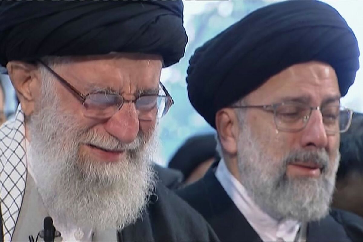 Iranian Supreme Leader Ayatollah Ali Khamenei weeps as he leads a prayer over the coffin of Gen. Qassem Suleimani.