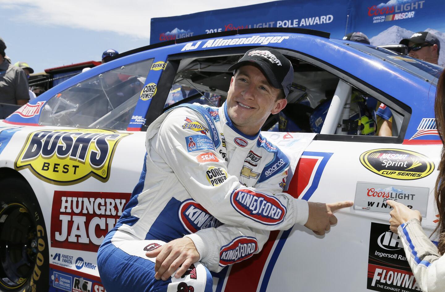 A.J. Allmendinger poses by his car after winning the pole position qualifying for the NASCAR Sprint Cup Series auto race Saturday, June 27, 2015, in Sonoma, Calif.