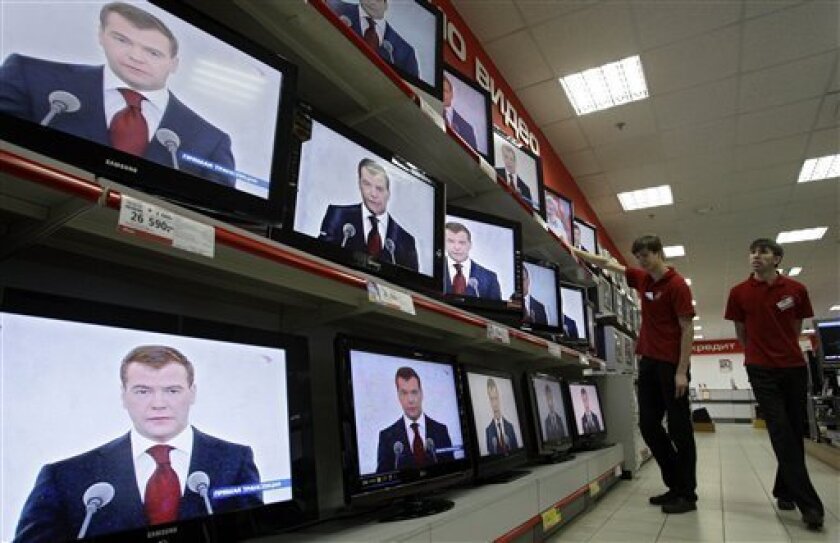 Shop assistants watch Russian President Dmitry Medvedev making the address to the nation at a Moscow shop on Wednesday, Nov. 5, 2008. Russian President Dmitry Medvedev assailed the United States on Wednesday in his first state of the nation address, vowing to deploy missiles near Poland in response to U.S. plans for a European shield. (AP Photo/Sergey Ponomarev)