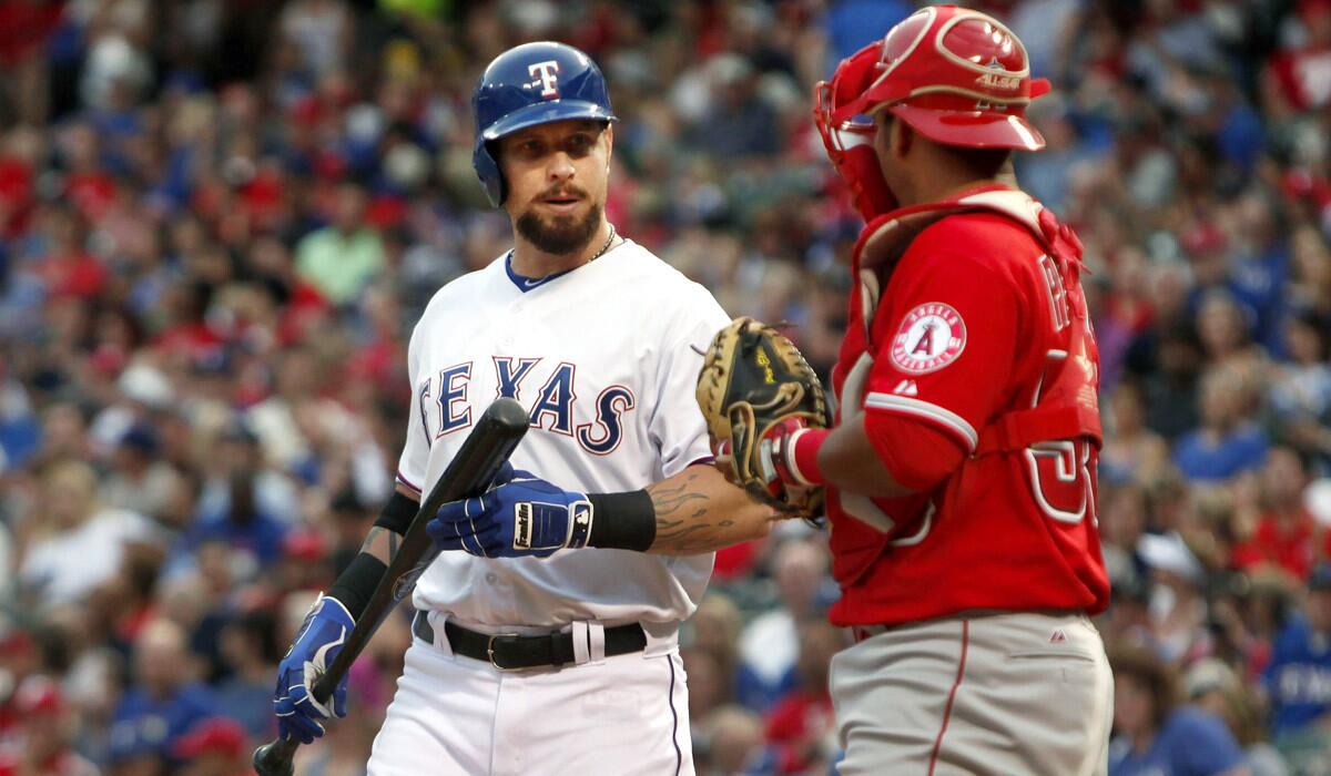 Texas Rangers' Josh Hamilton comes to the plate and talks with Los Angeles Angels catcher Carlos Perez during the second inning on Friday. It was the first time Hamilton faced his former team since being traded earlier in the season.