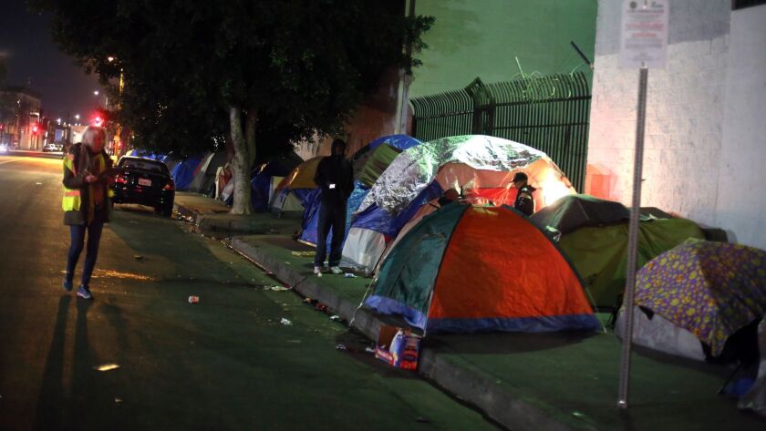 Volunteer Barbara Petersmeyer, left, looks at tents during this year’s point-in-time count