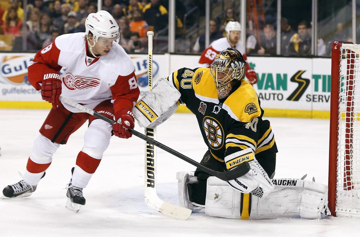 Bruins goalie Tuukka Rask makes a glove save as Red Wings winger Justin Abdelkader looks for a rebound in the third period of Game 2 on Sunday in Boston.