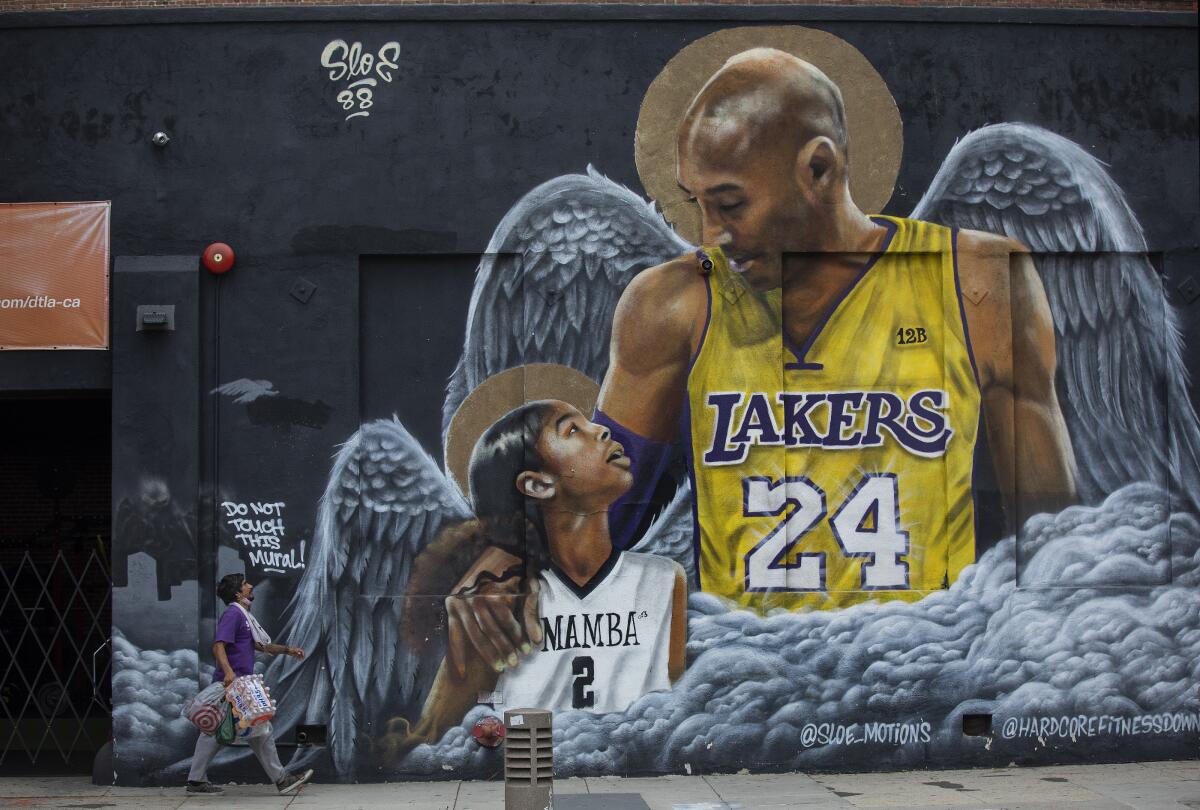 A mural shows Los Angeles Lakers legend Kobe Bryant looking down at his daughter Gianna, both with angel wings