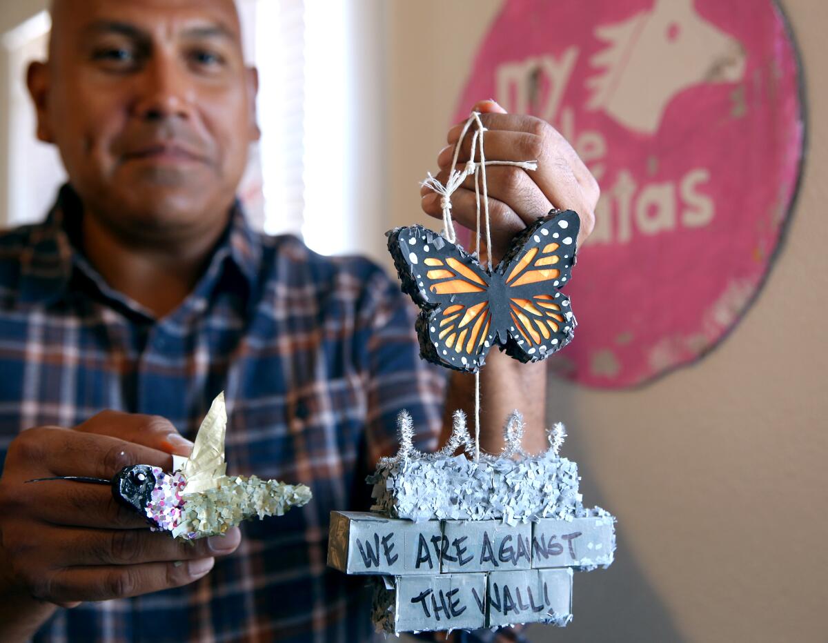 Isaias Rodriguez shows some of the mini pinatas he creates at his studio in Fresno.