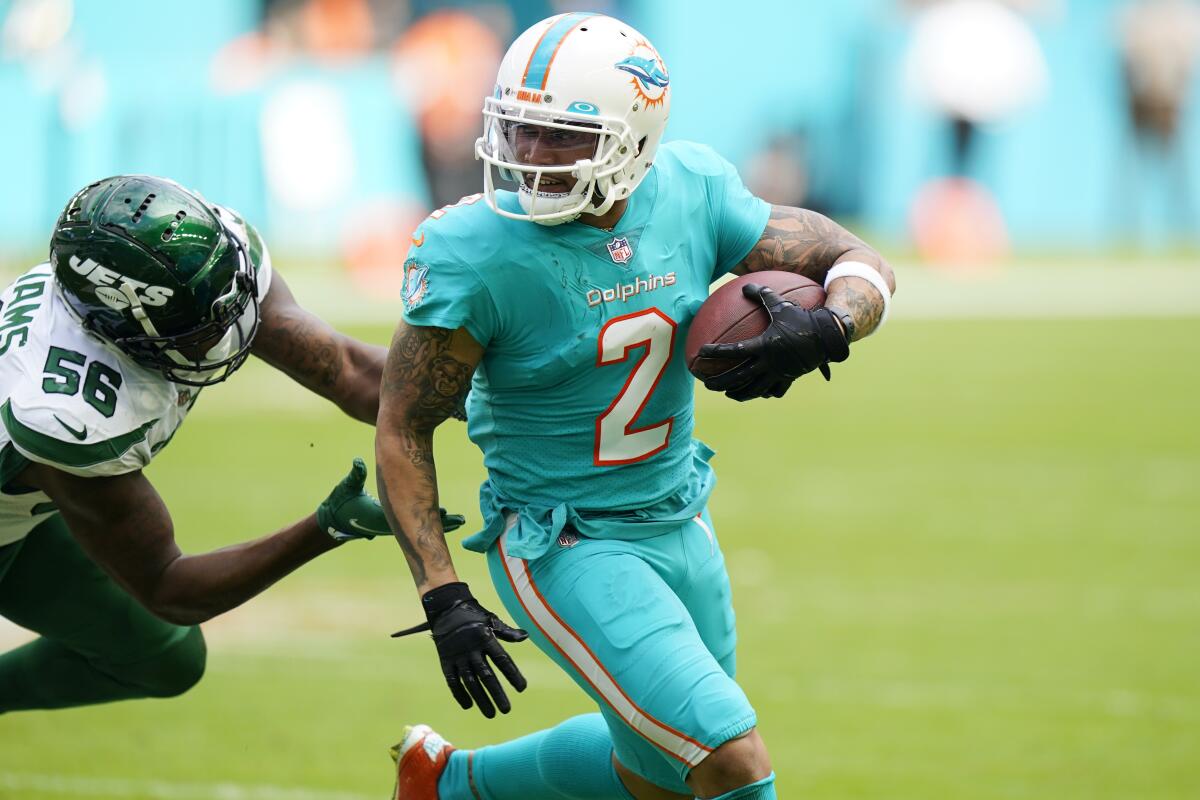 New York Jets outside linebacker Quincy Williams attempts to tackle Miami Dolphins wide receiver Albert Wilson.