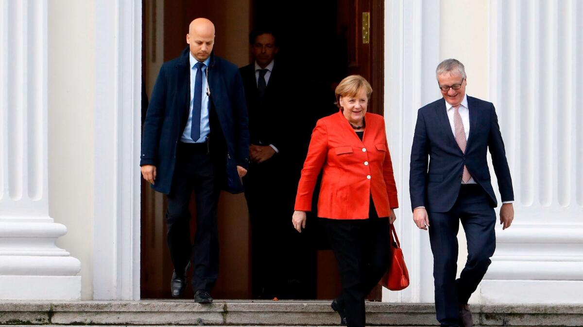 German Chancellor Angela Merkel leaves the presidential residence in Berlin, where she met with President Frank-Walter Steinmeier after talks on forming a new coalition government failed on Monday.